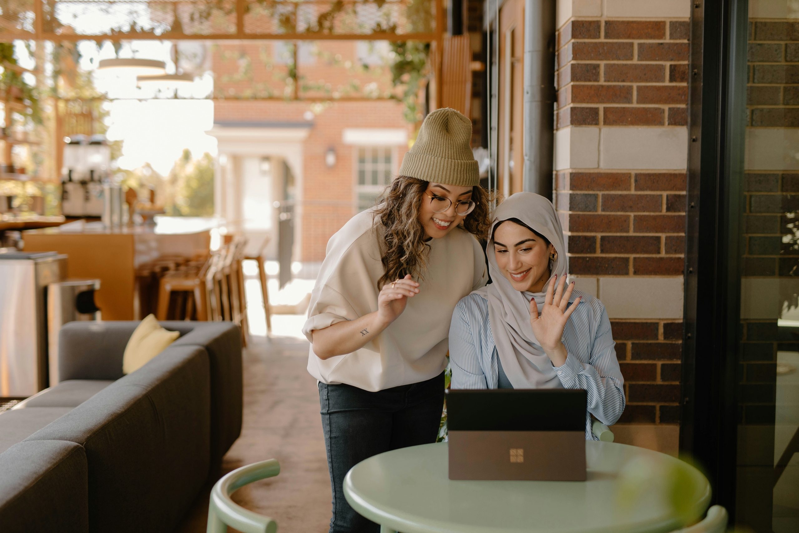 2 restaurant owners looking at restaurant insurance on their laptop